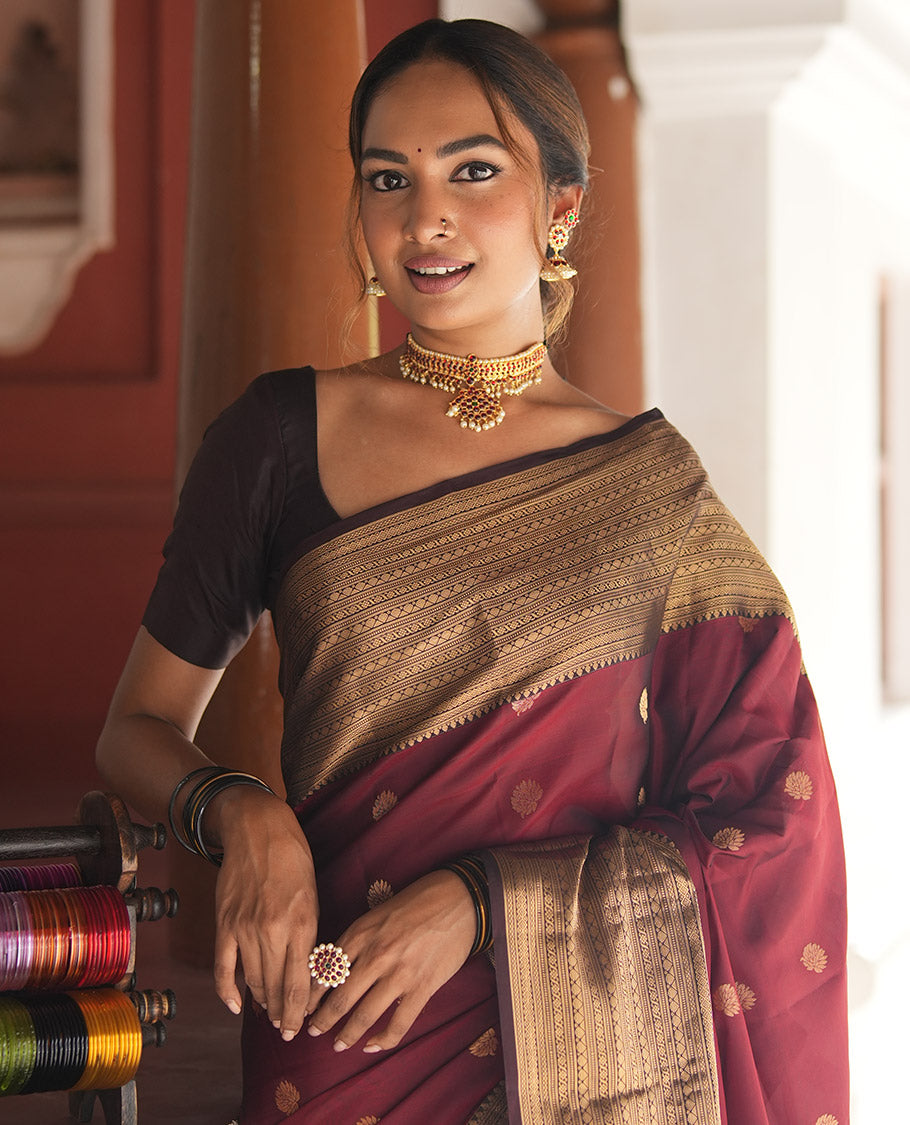 Wine and Maroon Vasundhara Lite Silk Mix Saree, Elevated with Zari Buttas All Over Its Body, Complemented by Contrast Border of Thilakam, Muthu, Banaras, Diamond, Mayil Kann, and Cross Kamalam Designs, Grand Pallu, and Paired with a Contrast Blouse