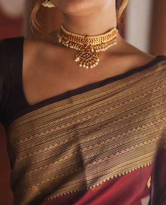 Wine and Maroon Vasundhara Lite Silk Mix Saree, Elevated with Zari Buttas All Over Its Body, Complemented by Contrast Border of Thilakam, Muthu, Banaras, Diamond, Mayil Kann, and Cross Kamalam Designs, Grand Pallu, and Paired with a Contrast Blouse