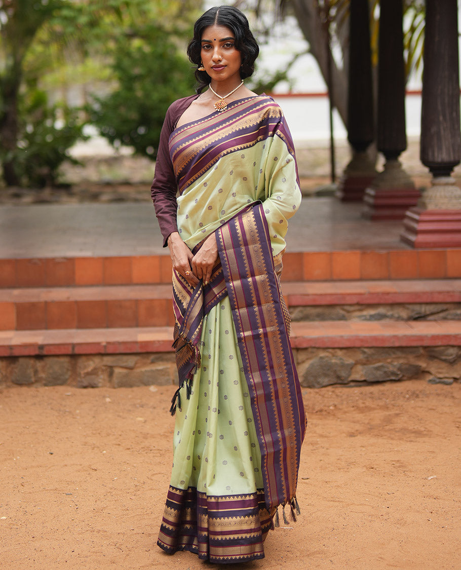 Pista Green and Coffee Brown Vasundenhara Lite Silk Mix Saree, Subtly Adorned with Buttas All Over Its Body, Complemted by Contrast Border of Thazampoo Rekku, Banaras, Jada Nagam, and Ara Maadam Designs, Grand Pallu, and Paired with a Contrast Blouse