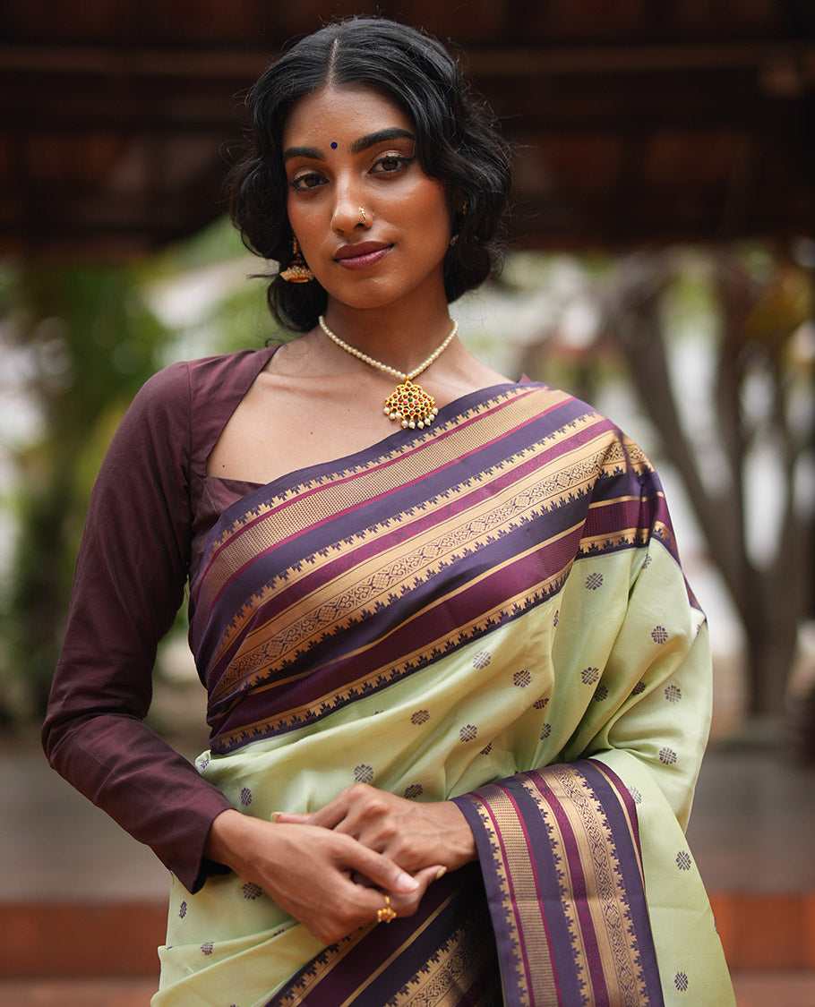Pista Green and Coffee Brown Vasundenhara Lite Silk Mix Saree, Subtly Adorned with Buttas All Over Its Body, Complemted by Contrast Border of Thazampoo Rekku, Banaras, Jada Nagam, and Ara Maadam Designs, Grand Pallu, and Paired with a Contrast Blouse
