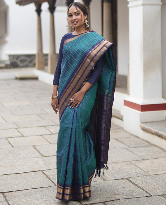 Mayil Color and Navy Blue Vasundhara Lite Silk Mix Saree, Graced with Checked Design All Over Its Body, Complemented by a Contrast Thazampoo Rekku Border of Manga Mokku, Muthu, and Mayil Kann Designs, Grand Pallu, and Paired with a Contrast Blouse