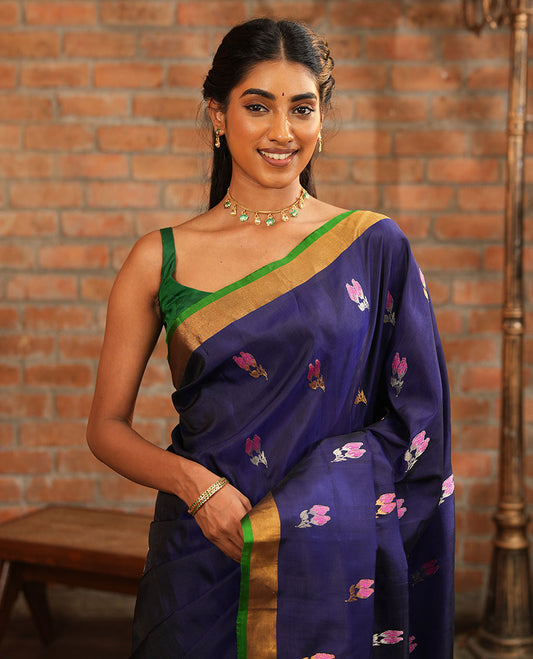 Blue Uppada Silk Saree Adorned with Meena Floral Buttas, Complemented by a Contrast Bavanji  Border, Pallu Steeped with Chevron Stripes, and Paired with a Contrast Blouse