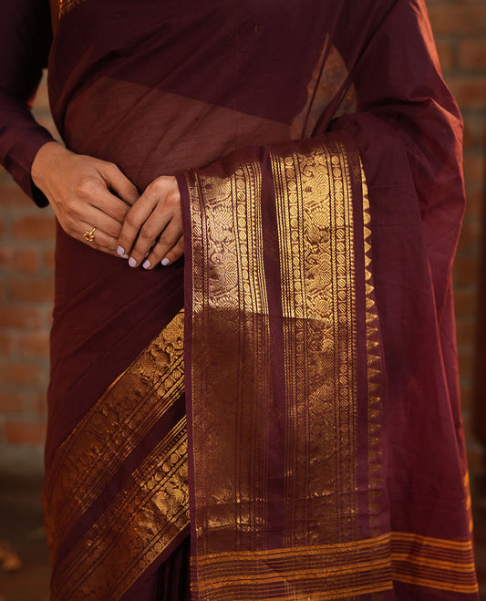 Brown Plain Chettinad Cotton Saree, Accentuated with a Gleaming Zari Rettai Pettu Border Featuring Elephant and Peacock Motifs, Subtly Striped Pallu, and Paired with a Matching Blouse