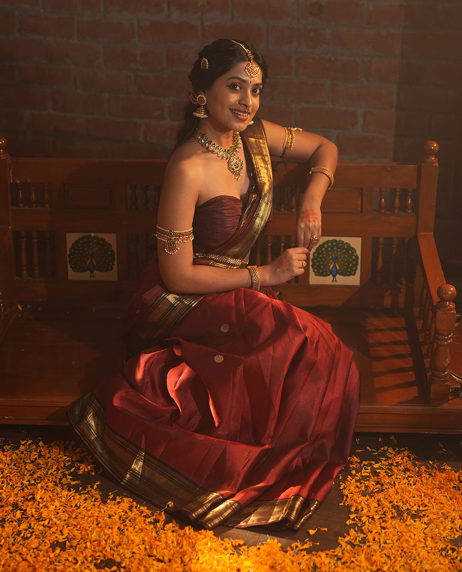Crimson Red Vasundhara Silk Saree Featuring Vaira Oosi, and Annam Chakram Buttas, Complemented by a Contrast Border of Thilakam, Banaras, Mayil, Mayil Kann, Ara Bogudi, Muthu, and Banaras Designs, Grandly Woven Pallu, and a Contrast Blouse