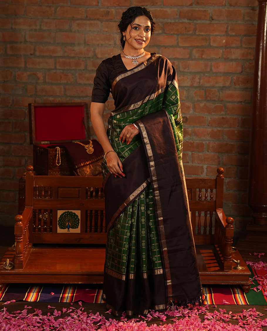 Green Vasundhara Silk Saree Richly Detailed with Chakram Butta Enclosed Checks, Highlighted with a Contrast Rettai Pettu of Rekku, Muthu, and Dhavana Kodi Designs, Zari-Rich Pallu of Jaal Designs, and Paired with a Contrast Blouse
