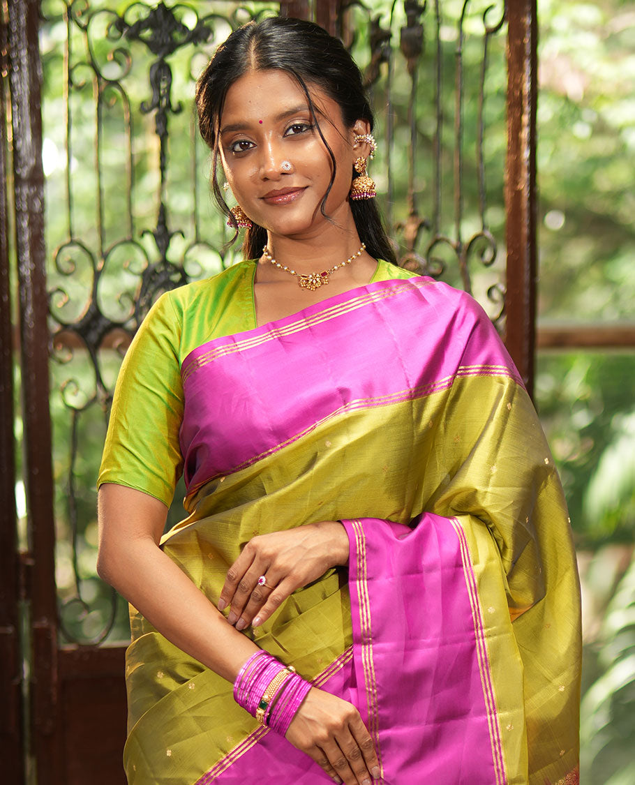 Green Vasundhara Lite-Silk Mix Saree, Beautifully Decorated with Zari Buttas All Over Its Body, Complemented by Contrast Rettai Pettu Border of Zari Stripes, Pallu Accentuated with Jaal Designs, and Paired with a Contrast Blouse