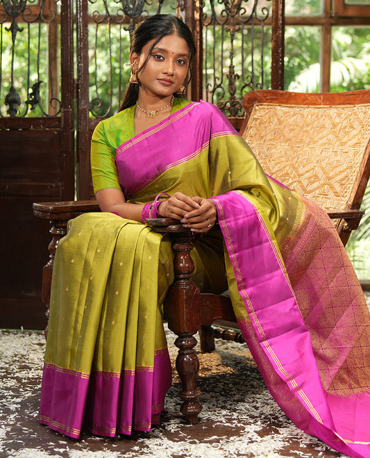 Green Vasundhara Lite-Silk Mix Saree, Beautifully Decorated with Zari Buttas All Over Its Body, Complemented by Contrast Rettai Pettu Border of Zari Stripes, Pallu Accentuated with Jaal Designs, and Paired with a Contrast Blouse