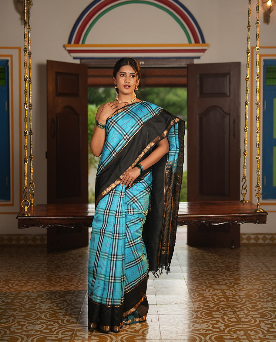 Blue-Black Vasundhara Lite Silkmix Saree Features Checks, Contrast Rettai Pettu Rekku-Poun Border, Zari-Striped Pallu, and a Contrast Blouse