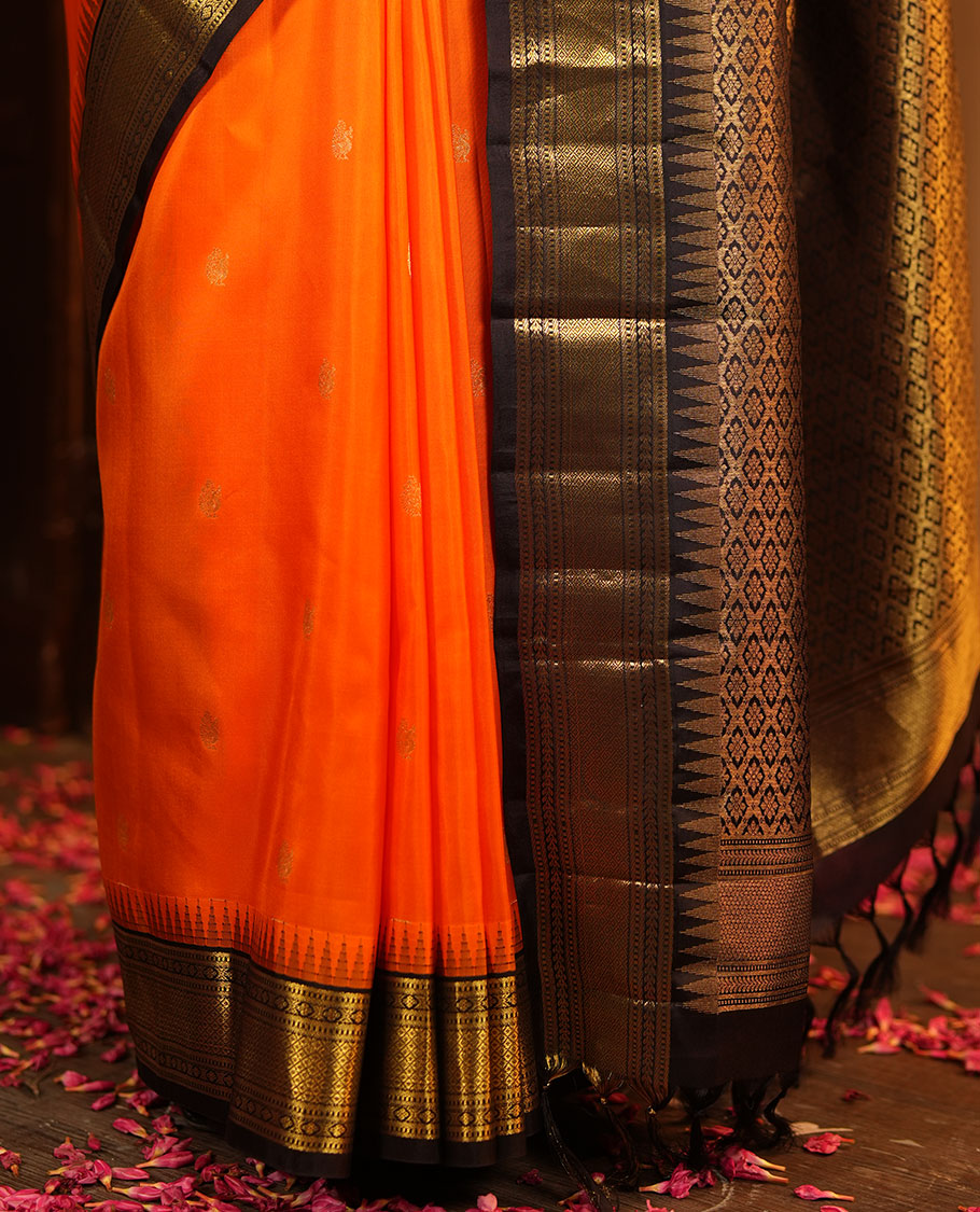 Orange Vasundhara Silk Saree, Artfully Woven with Mayil Buttas All Over Its Body, Complemented by Contrast Border Featuring Thazampoo Rekku, Muthu, Lavangam, and Mayil Kann Designs, a Grand Pallu of Jaal Designs, and Paired with a Contrast Blouse