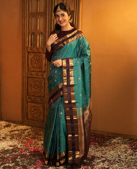 Peacock Color Vasundhara Lite-Silk Mix Saree, Artfully Designed with Mayil-Chakram Buttas and Zari Checks On Its Body, Complemented by Captivating Contrast Border of Rekku, and Chakram Designs, Gracefully Embellished Pallu, Paired with a Contrast Blouse