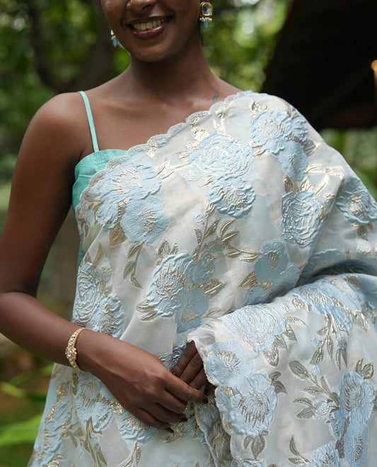 Sky Blue Turkey Organza Saree Features Floral Gold-Glitter work, Scallop Border, a Embroidered Blouse