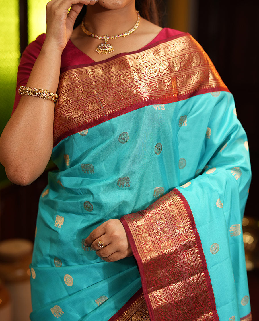 Blue Vasundhara Silk Saree, Embellished with Mayil and Yaanai Buttas Across Its Body, Complemented by a Contrast Korvai Border of Rekku, Banaras, Yaanai, and Chakram Designs, Gleaming Jaal Pallu, and Paired with a Contrast Blouse