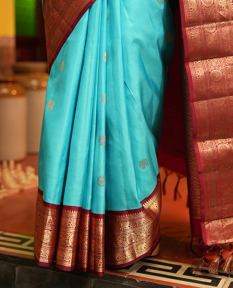 Blue Vasundhara Silk Saree, Embellished with Mayil and Yaanai Buttas Across Its Body, Complemented by a Contrast Korvai Border of Rekku, Banaras, Yaanai, and Chakram Designs, Gleaming Jaal Pallu, and Paired with a Contrast Blouse