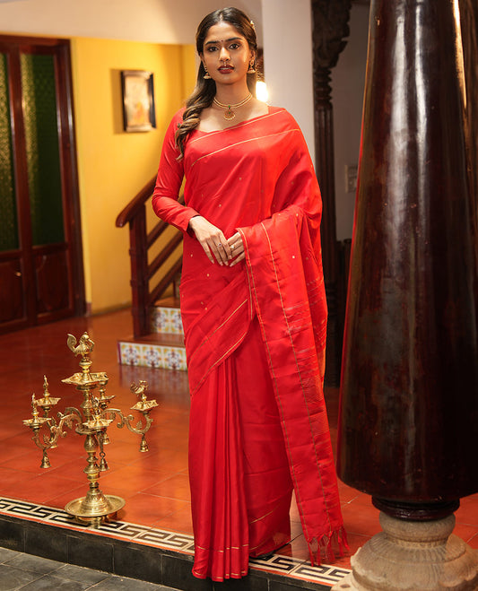 Red Vasundhara Lite Silk Saree, Subtly Sparkled with Paisa Zari Buttas Across Its Body, Highlighted Zari Border of Horizontal Stripes, Gleaming Pallu of Seppu Rekku Designs, and Paired with a Matching Blouse