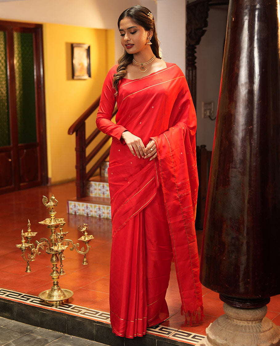 Red Vasundhara Lite Silk Saree, Subtly Sparkled with Paisa Zari Buttas Across Its Body, Highlighted Zari Border of Horizontal Stripes, Gleaming Pallu of Seppu Rekku Designs, and Paired with a Matching Blouse
