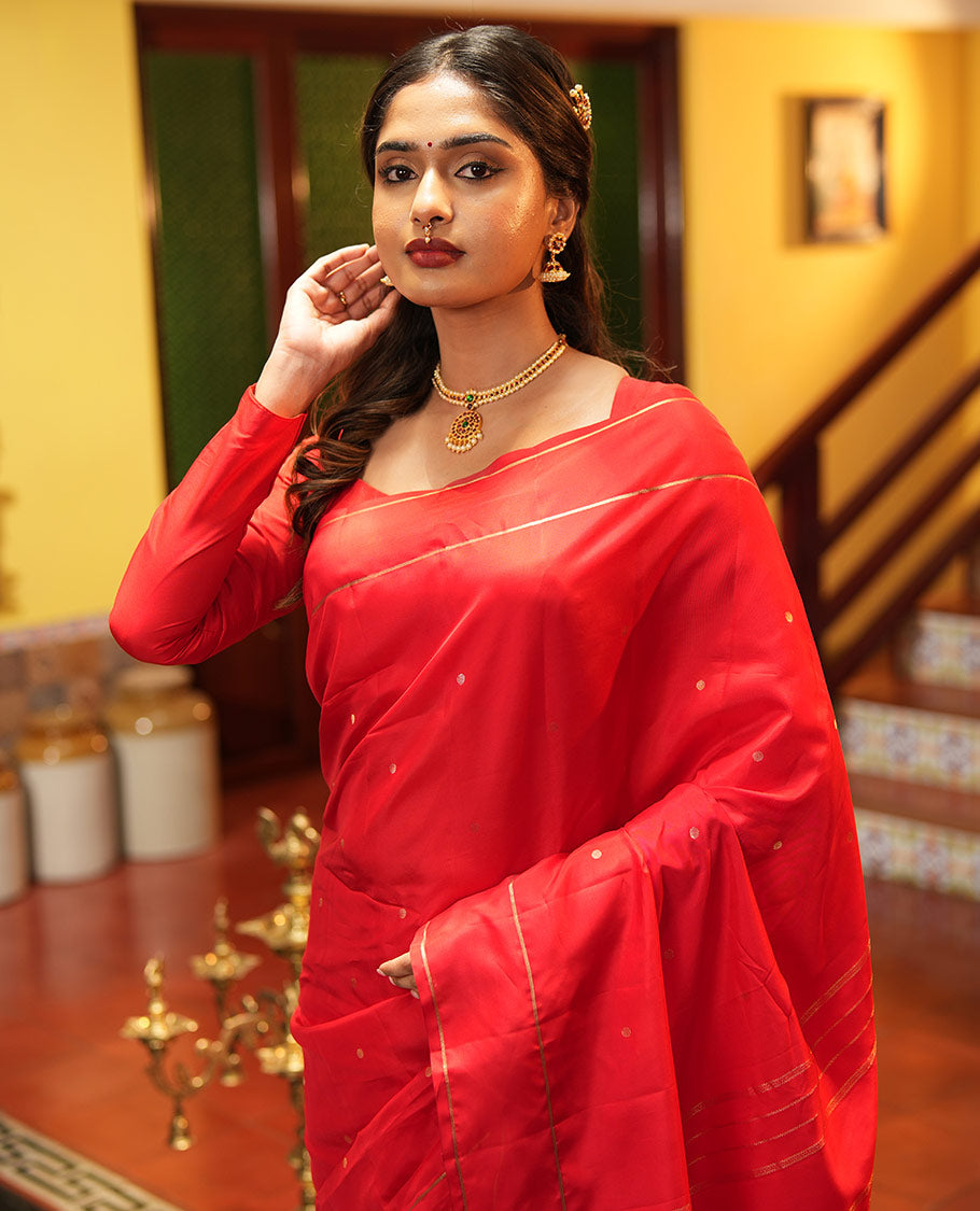 Red Vasundhara Lite Silk Saree, Subtly Sparkled with Paisa Zari Buttas Across Its Body, Highlighted Zari Border of Horizontal Stripes, Gleaming Pallu of Seppu Rekku Designs, and Paired with a Matching Blouse