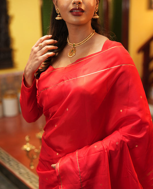 Red Vasundhara Lite Silk Saree, Subtly Sparkled with Paisa Zari Buttas Across Its Body, Highlighted Zari Border of Horizontal Stripes, Gleaming Pallu of Seppu Rekku Designs, and Paired with a Matching Blouse