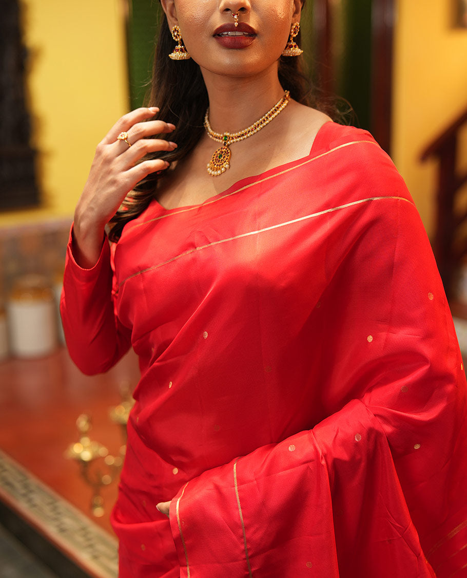 Red Vasundhara Lite Silk Saree, Subtly Sparkled with Paisa Zari Buttas Across Its Body, Highlighted Zari Border of Horizontal Stripes, Gleaming Pallu of Seppu Rekku Designs, and Paired with a Matching Blouse
