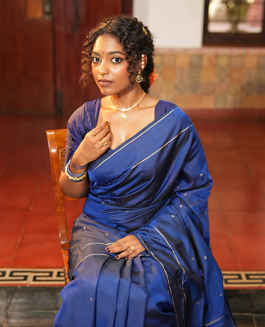 Navy Blue Vasundhara Lite Silk Saree, Subtly Sparkled with Paisa Zari Buttas Across Its Body, Highlighted Zari Border of Horizontal Stripes, Gleaming Pallu of Seppu Rekku Designs, and Paired with a Matching Blouse