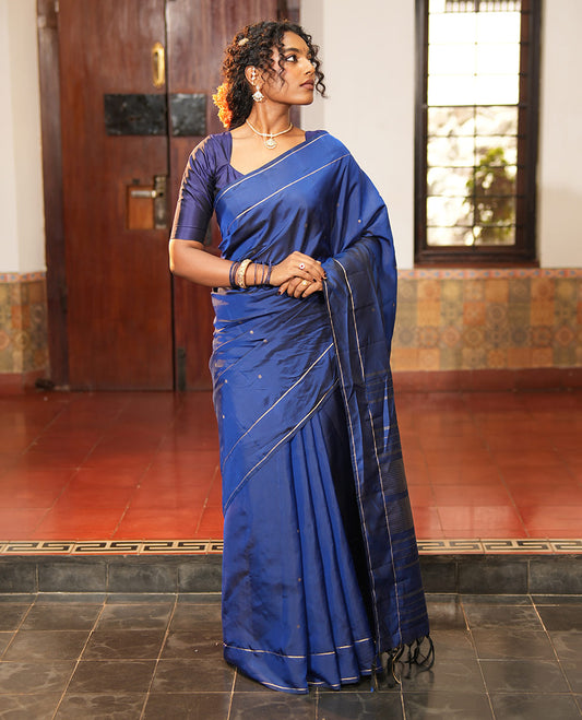 Navy Blue Vasundhara Lite Silk Saree, Subtly Sparkled with Paisa Zari Buttas Across Its Body, Highlighted Zari Border of Horizontal Stripes, Gleaming Pallu of Seppu Rekku Designs, and Paired with a Matching Blouse