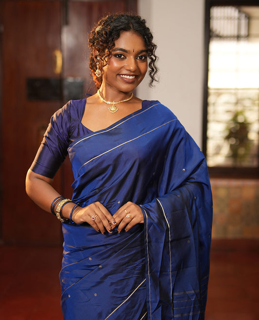 Navy Blue Vasundhara Lite Silk Saree, Subtly Sparkled with Paisa Zari Buttas Across Its Body, Highlighted Zari Border of Horizontal Stripes, Gleaming Pallu of Seppu Rekku Designs, and Paired with a Matching Blouse