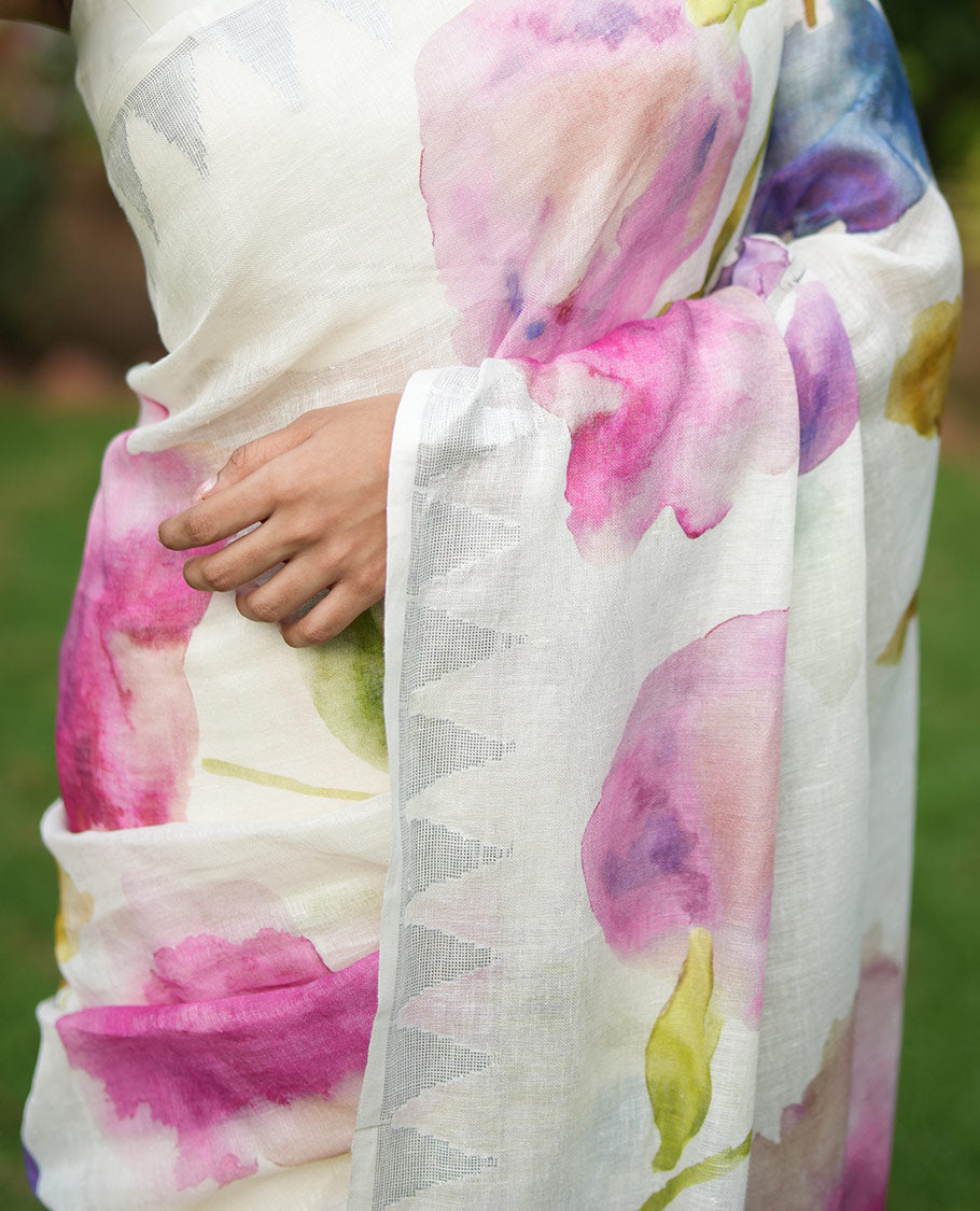 Cream-Base Linen Saree, Highlighted by Floral-Themed Paint Splashes, Hand-Brush Painted All Over Its Body, Sparsely Woven Temple Border, and Paired with a Matching Blouse