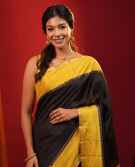 Black Plain Semi-Tussar Silk Saree, Complemented by a Contrast Geometric Design Border, Subtly Zari Striped Pallu, and Paired with a Contrast Floral Vine Printed Blouse