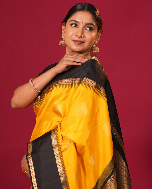 Yellow zari buttas silk saree, contrast thazampoo rekku rettai pettu border of banaras, and manga designs, and jaal pallu