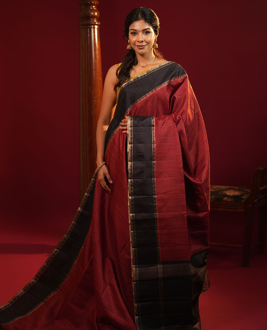 Maroon Plain Semi-Tussar Silk Saree, Complemented by a Contrast Geometric Design Border, Subtly Zari Striped Pallu, and Paired with a Contrast Floral Vine Printed Blouse