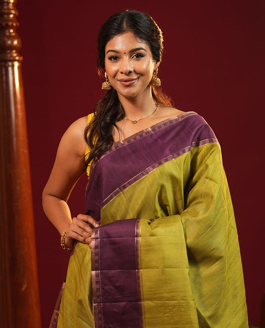 Olive Green Plain Semi-Tussar Silk Saree, Complemented by a Contrast Geometric Design Border, Subtly Zari Striped Pallu, and Paired with a Contrast Patola Printed Blouse