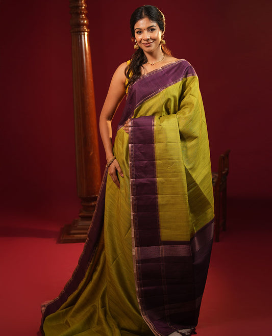 Olive Green Plain Semi-Tussar Silk Saree, Complemented by a Contrast Geometric Design Border, Subtly Zari Striped Pallu, and Paired with a Contrast Patola Printed Blouse