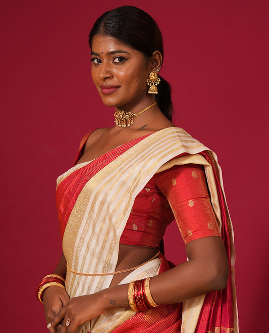 Orange muthu kattam and zari buttas silk saree, contrast varisai pettu border of thilakam, muthu, and rudraksham designs, and jaal pallu