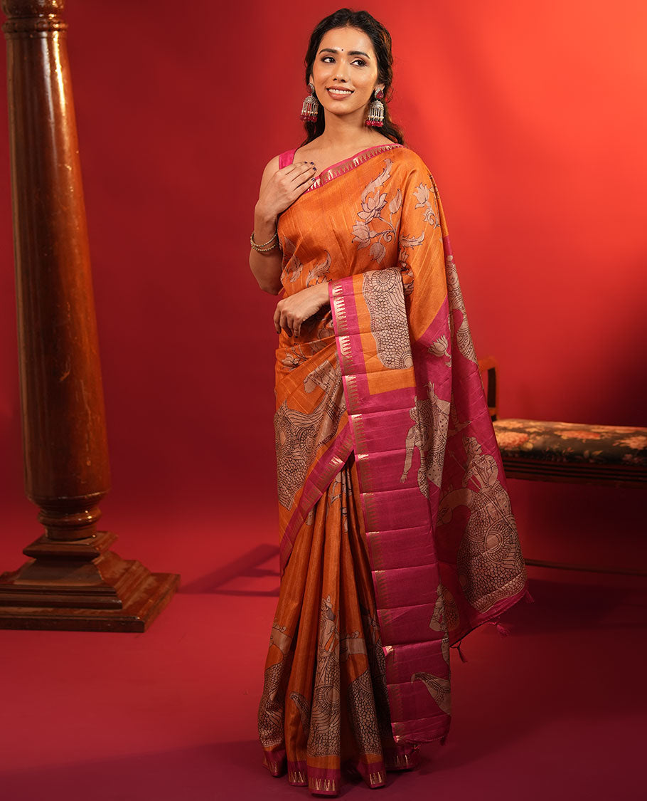 Orange Semi-Tussar Silk Saree, Artfully Detailed with Kalamkari-Style Human Motifs Printed on Its Body, Complemented by a Contrast Temple Zari Border, Creatively Kalamkari Printed Pallu, and Paired with a Contrast Blouse