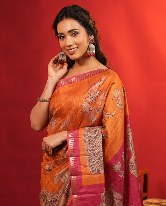 Orange Semi-Tussar Silk Saree, Artfully Detailed with Kalamkari-Style Human Motifs Printed on Its Body, Complemented by a Contrast Temple Zari Border, Creatively Kalamkari Printed Pallu, and Paired with a Contrast Blouse
