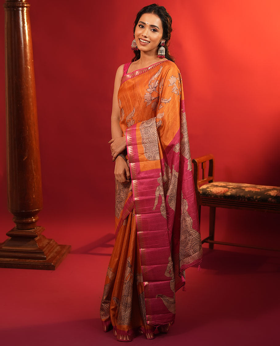 Orange Semi-Tussar Silk Saree, Artfully Detailed with Kalamkari-Style Human Motifs Printed on Its Body, Complemented by a Contrast Temple Zari Border, Creatively Kalamkari Printed Pallu, and Paired with a Contrast Blouse