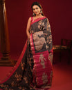 Black Semi-Tussar Silk Saree, Gracefully Detailed with Kalamkari-Style Human Motifs Printed on Its Body, Complemented by a Contrast Temple Zari Border, Creatively Kalamkari Printed Pallu, and Paired with a Contrast Blouse