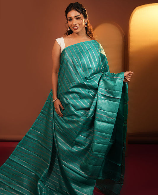 Borderless Green Tussar Silk Saree, Adorned With Zari Stripes All Over Its Body, Highlighted by Self-Pallu and Paired with a Matching Blouse