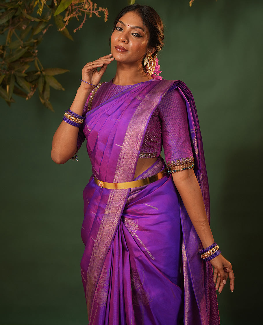 Violet Vasundhara Silk Saree Accentuated with Thazampoo Rekku, and Vel Buttas, Complemented by Zari Border of Manga, Muthu, Kathir, Neli, and Vanki Designs, Pallu Adorned with Jaal Designs, and Paired with a Matching Blouse