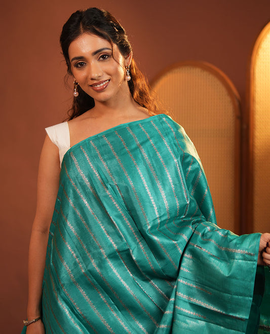 Borderless Green Tussar Silk Saree, Adorned With Zari Stripes All Over Its Body, Highlighted by Self-Pallu and Paired with a Matching Blouse