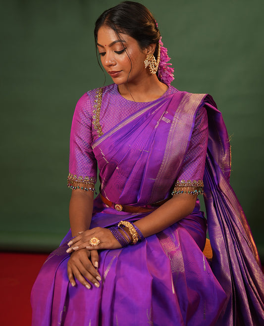 Violet Vasundhara Silk Saree Accentuated with Thazampoo Rekku, and Vel Buttas, Complemented by Zari Border of Manga, Muthu, Kathir, Neli, and Vanki Designs, Pallu Adorned with Jaal Designs, and Paired with a Matching Blouse
