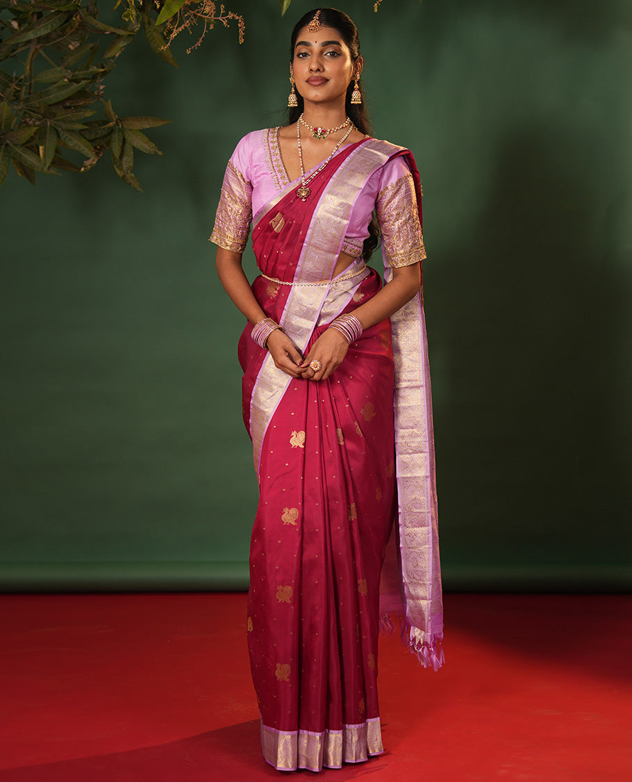 Pink Vasundhara Silk Saree Elevated with Yaanai and Mayil Buttas, Complemented by a Contrast Border of Muthu, Kathir, Mayil, and Yaanai Designs, Pallu Embellished with Diagonal Stripes, and Paired with a Contrast Blouse