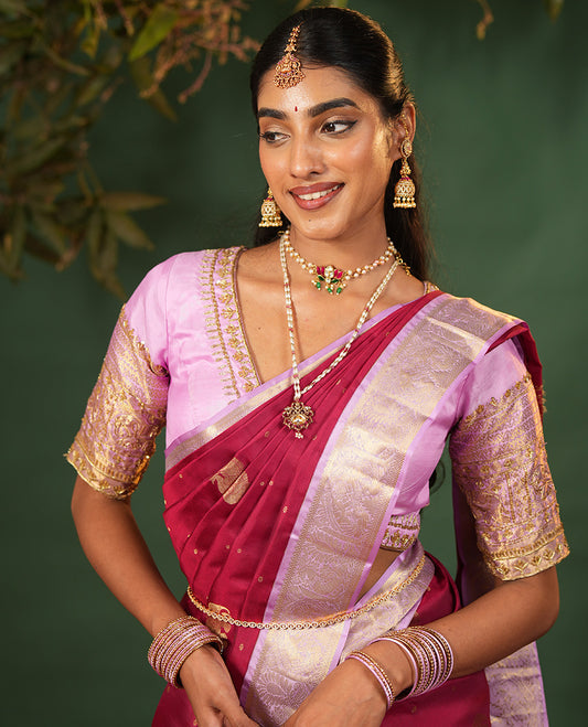 Pink Vasundhara Silk Saree Elevated with Yaanai and Mayil Buttas, Complemented by a Contrast Border of Muthu, Kathir, Mayil, and Yaanai Designs, Pallu Embellished with Diagonal Stripes, and Paired with a Contrast Blouse