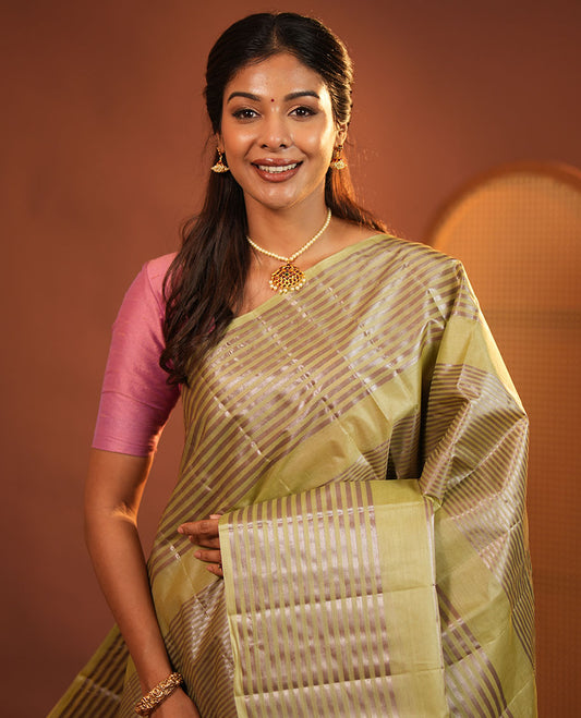 Green Tussar Silk Saree, Highlighted by Horizontal Zari Stripes Running All Over Its Body, Highlighted by Zari Striped Border, Zari Gleamed up Pallu, and Paired with a Matching Blouse