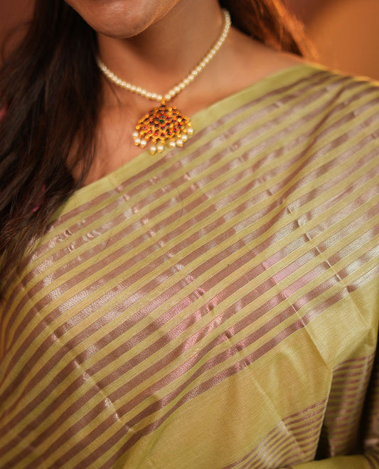 Green Tussar Silk Saree, Highlighted by Horizontal Zari Stripes Running All Over Its Body, Highlighted by Zari Striped Border, Zari Gleamed up Pallu, and Paired with a Matching Blouse