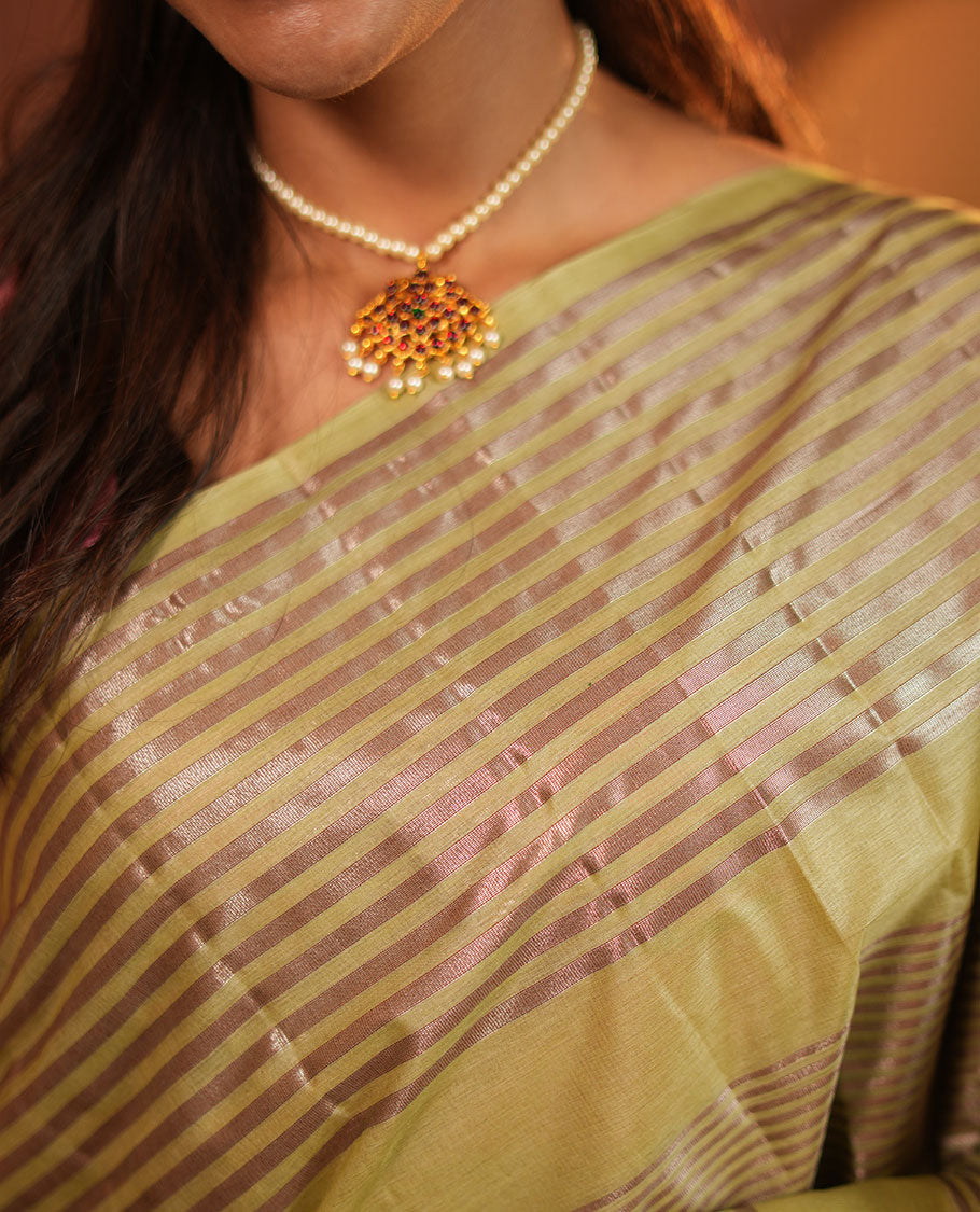 Green Tussar Silk Saree, Highlighted by Horizontal Zari Stripes Running All Over Its Body, Highlighted by Zari Striped Border, Zari Gleamed up Pallu, and Paired with a Matching Blouse