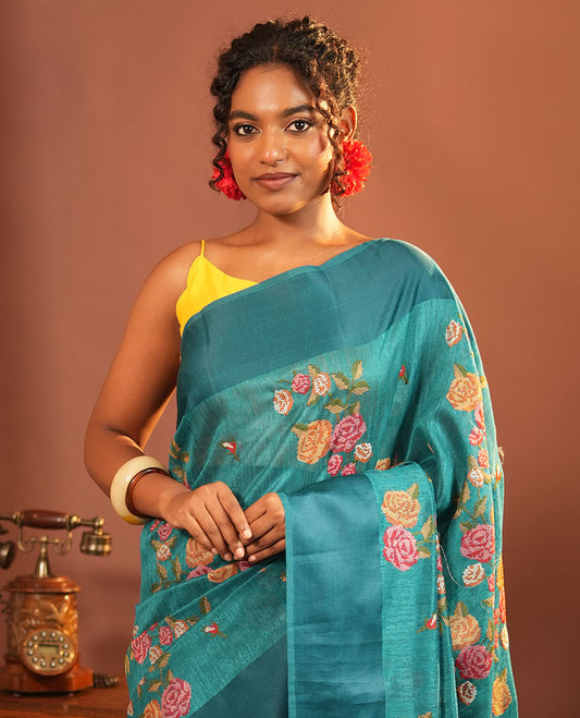 Rama Blue Green-Silk Saree, Colorfully Highlighted with Rose Motifs Cross Stitch Embroidery on Its Body, Subtly Sparkled by a Plain Border, Pallu of Rose Cross Stitch Embroidery, and Paired with a Contrast Blouse