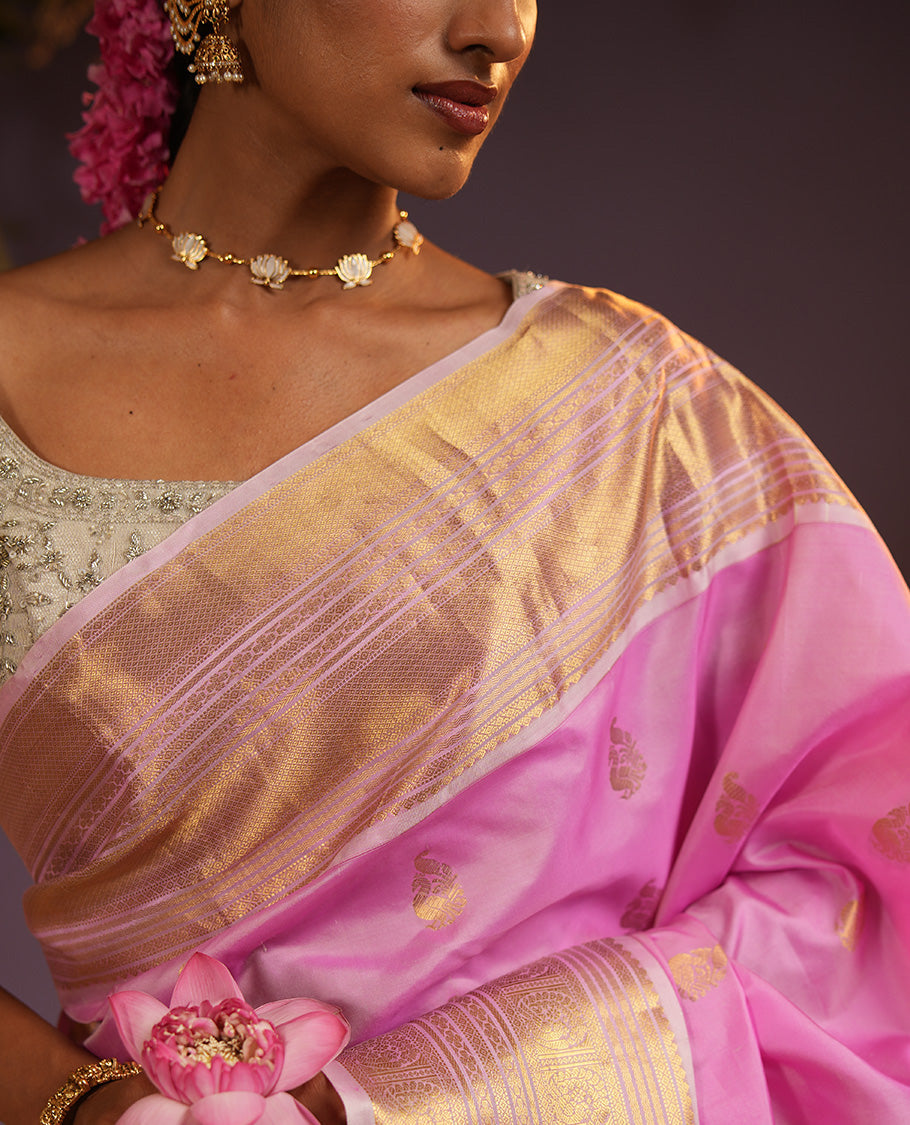 Pink mayil buttas Vasundhara silk saree, zari border of muthu, diamond, mayil kann, kamalam, and mayil designs, and intricate pallu