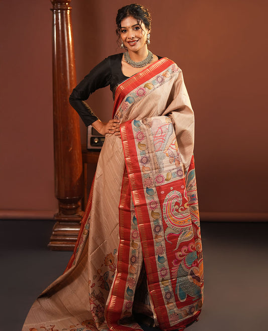 Chikku-Red Fancy Tussar Saree, Artfully Detailed with Kalamkari-Style Floral Print Across Its Body, Complemented by Contrast Temple Zari Border, a Colourfully Kalamkari Printed Pallu, and Paired with a Plain Blouse