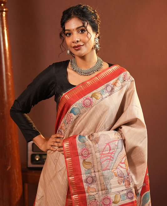 Chikku-Red Fancy Tussar Saree, Artfully Detailed with Kalamkari-Style Floral Print Across Its Body, Complemented by Contrast Temple Zari Border, a Colourfully Kalamkari Printed Pallu, and Paired with a Plain Blouse