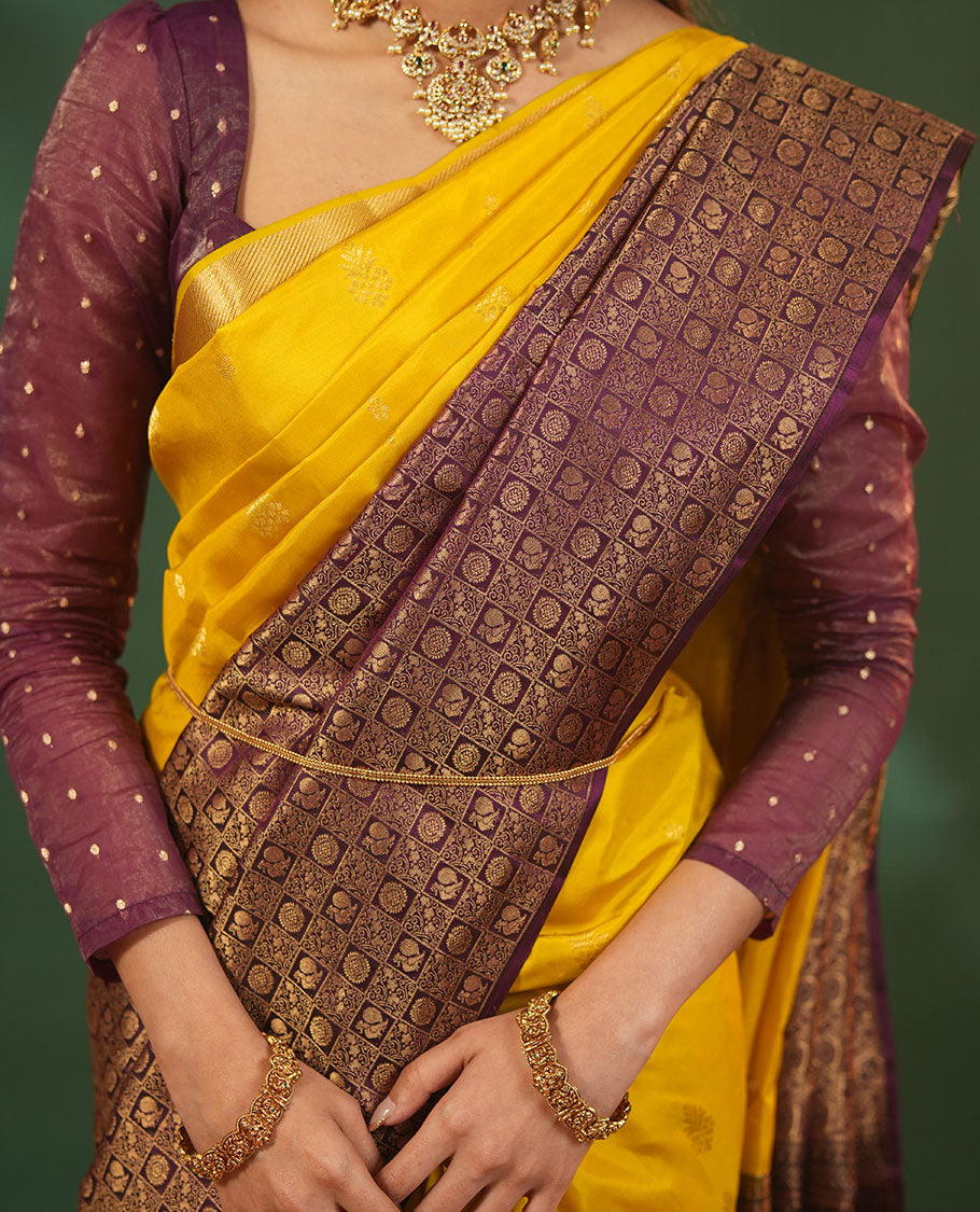 Yellow Vasundhara Silk Saree Featuring Floral Zari Buttas and Skrit-Border-Style Contrast Annam Chakram Butta Enclosed Checked Border, Majestically Zari Detailed Pallu, and Paired with a Contrast Blouse